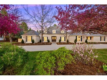 Charming brick home features a well-manicured front yard and a large driveway, perfect for Gathering living at 38 Sedgwick Dr, Cherry Hills Village, CO 80113