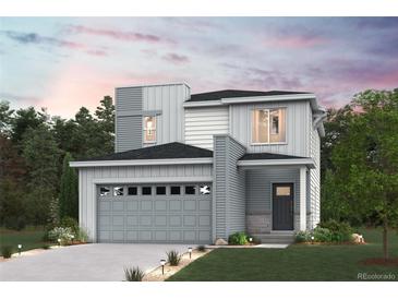 Stunning two-story home featuring a modern design, attached two car garage, and professional landscaping at 19079 E 94Th Pl, Commerce City, CO 80022