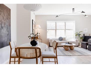 Inviting living area with stylish dining set, comfortable seating, and bright natural light at 1440 Little Raven St # 107, Denver, CO 80202