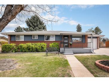 Charming single-story home featuring a brick facade, a well-manicured lawn, and a cozy front bench at 6576 S Lincoln St, Centennial, CO 80121