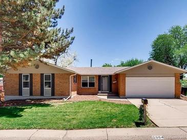 Charming single-story brick home featuring a well-maintained lawn, mature trees, and attached two-car garage at 2964 S Akron St, Denver, CO 80231