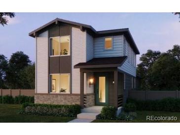 Modern two-story home featuring a welcoming porch, large windows, and contemporary design elements at 21144 E 63Rd Dr, Aurora, CO 80019