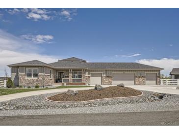 Charming home featuring stone accents, a three-car garage, and a meticulously landscaped front yard at 8625 E 125Th Ct, Thornton, CO 80602