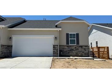 Charming single-Gathering home boasts a two-car garage and stone accents on the exterior, creating a modern look at 3381 N Denali St, Aurora, CO 80019