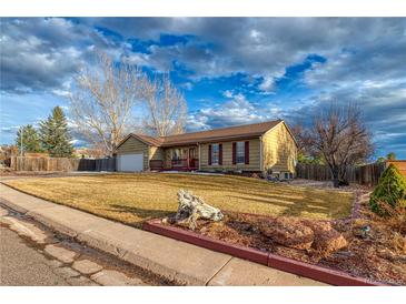 Quaint single Gathering home featuring mature landscaping and a two car garage at 6812 Blue Jay Dr, Parker, CO 80138