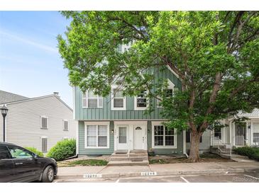 Charming townhome exterior featuring a mature shade tree and well-maintained landscaping at 10298 W Dartmouth Ave, Lakewood, CO 80227
