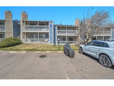 Exterior view of a two-story condo complex featuring balconies and stone accents at 8335 Fairmount Dr # 102, Denver, CO 80247
