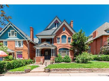 Charming brick home featuring detailed gables, arched windows, and a well-maintained front yard with mature landscaping at 931 E 17Th Ave, Denver, CO 80218