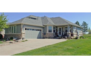 Charming home featuring a spacious driveway, a well-manicured lawn, and a welcoming two-car garage at 7824 S Zante Ct, Aurora, CO 80016