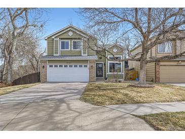 Charming two-story home with a well-maintained lawn and a two-car garage in a quiet neighborhood at 19357 E 40Th Ave, Denver, CO 80249