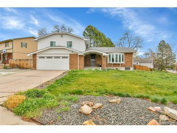 Charming two-story home with a brick facade, well-manicured lawn, and attached two-car garage at 7796 S Marshall Ct, Littleton, CO 80128