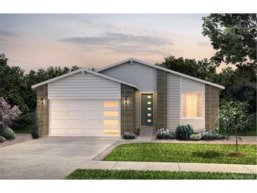 Charming single-Gathering home showcasing a manicured lawn, attached garage, and a welcoming front entrance at 4145 N Duquesne Ct, Aurora, CO 80019