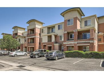 Exterior of a multi-story apartment building featuring brick accents and well-maintained landscaping at 4100 Albion St # 611, Denver, CO 80216