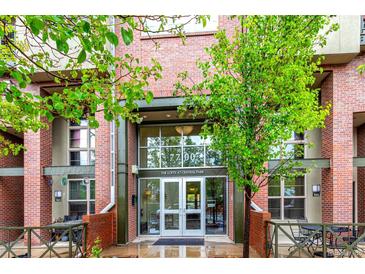 Inviting entrance of The Lofts at Central Park, showcasing brick facade and modern glass doors at 7700 E 29Th Ave # 405, Denver, CO 80238