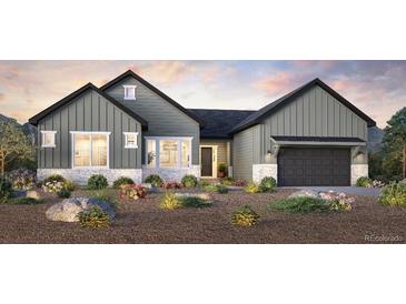 Charming gray home with board and batten siding, stone accents, and a well-manicured lawn at 5934 Riesberg Ln, Castle Rock, CO 80104