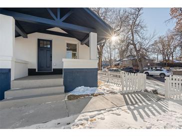 Charming craftsman home with a welcoming front porch and picket fence at 2758 W 38Th Ave, Denver, CO 80211