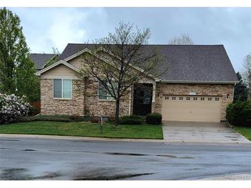 One-story home with stone accents and a two-car garage at 13349 Krameria St, Thornton, CO 80602