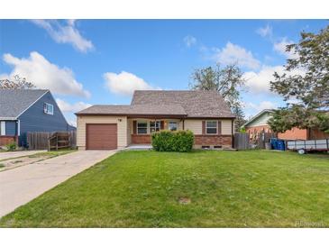 Charming single-story home featuring a well-maintained lawn, attached garage, and beautiful blue sky at 3270 W 92Nd Pl, Westminster, CO 80031