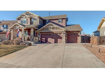 Two-story home featuring a wide driveway and a charming craftsman style design at 10265 Olathe St, Commerce City, CO 80022