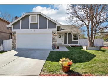 Charming home featuring a two-car garage, well-manicured lawn, and appealing landscaping at 1292 W 133Rd Cir, Westminster, CO 80234
