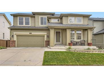 Inviting home with a two-car garage, quaint front porch and attractive, landscaped yard at 9680 Burberry Way, Highlands Ranch, CO 80129