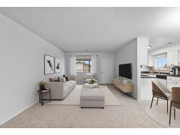 Bright living room with open concept floor plan, featuring a sofa and adjacent dining area at 9868 Appletree Pl, Thornton, CO 80260