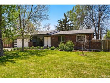 Charming brick home with a well-manicured lawn and vibrant green landscape, perfect for suburban living at 7413 S Tamarac St, Centennial, CO 80112