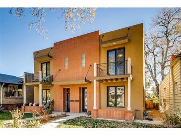 Inviting exterior showcasing a modern duplex with brick accents, balconies, and manicured landscaping at 3122 Perry St, Denver, CO 80212