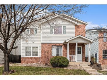 Charming two-story home featuring a combination of brick and siding and a cozy front porch at 10700 Kimblewyck Cir # 225, Northglenn, CO 80233