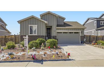 Attractive home featuring grey siding, brick accents, and a manicured lawn at 6924 E 118Th Pl, Thornton, CO 80233