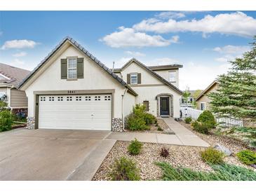 Charming two-story home featuring a well-manicured lawn, mature landscaping and a two car garage at 3841 Colorful Ln, Castle Rock, CO 80109