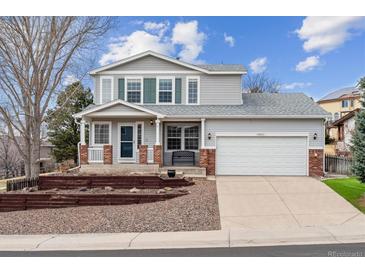 Charming two-story home with a well-manicured front yard and attached two-car garage at 10825 Mount Antero Way, Parker, CO 80138