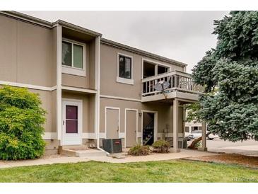 Multi-level townhouse featuring neutral toned siding and landscaping at 7973 Chase Cir # 56, Arvada, CO 80003