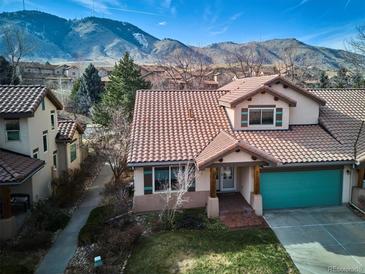 Lovely stucco home with teal garage door and mountain views at 1060 Cottonwood Cir, Golden, CO 80401