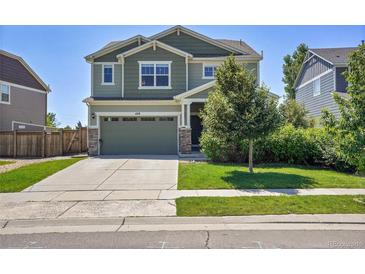 Charming two-story home showcasing a well-manicured lawn, inviting curb appeal, and a two-car attached garage at 428 Starline Ave, Lafayette, CO 80026