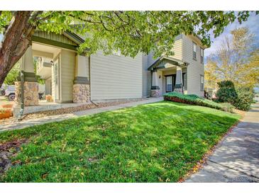 Two-story home with a well-manicured lawn and tasteful stone accents on the front porch columns at 13033 Grant E Cir # B, Thornton, CO 80241