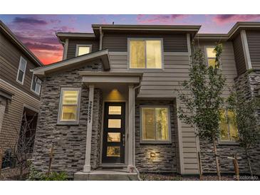 Two-story home with stone and siding exterior, modern entryway at 24257 E 41St Ave, Aurora, CO 80019