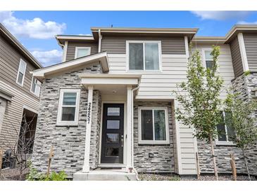 Charming townhome with stone facade, modern black door, and well-maintained landscaping at 24257 E 41St Ave, Aurora, CO 80019