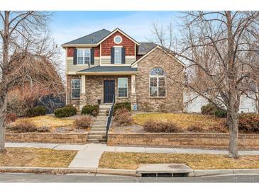 Charming two-story brick home with a well-maintained front yard and inviting curb appeal at 1082 Roslyn St, Denver, CO 80230