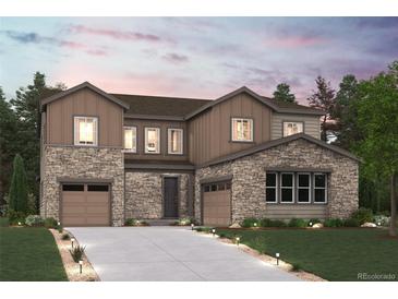 Beautiful two-story home boasts stone accents, a welcoming driveway and professional landscaping at 1783 Morgan Dr, Erie, CO 80516