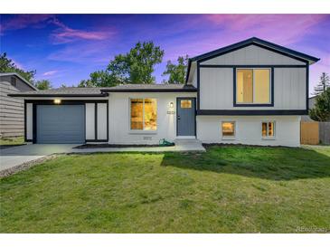 Charming two-story home with a well-maintained lawn, painted in white and gray at 9605 Carr St, Broomfield, CO 80021