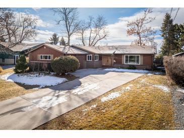 Charming home with a long driveway and landscaped front yard at 4470 W Lakeridge Rd, Denver, CO 80219