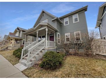 Charming two-story home features a welcoming front porch, complemented by well-maintained landscaping at 9486 E 107Th Ave, Commerce City, CO 80640