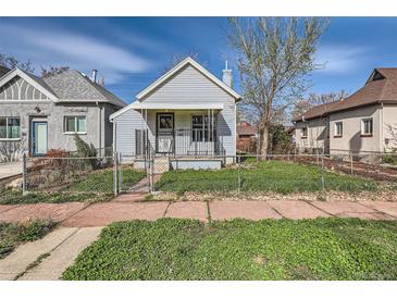 Charming home with a fenced yard and a welcoming front porch, complemented by blue sky at 339 Delaware St, Denver, CO 80223