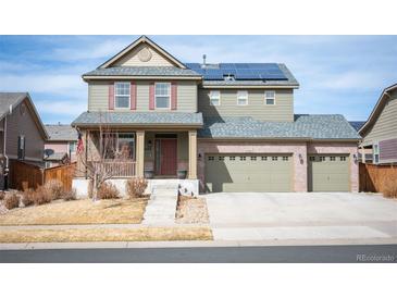 Charming two-story home with three-car garage, solar panels, and well-maintained front yard at 25403 E 2Nd Ave, Aurora, CO 80018