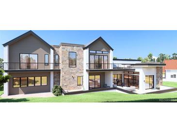 Stunning modern home featuring a stone facade, multiple balconies, and expansive windows providing ample natural light at 1055 Greens Pl, Erie, CO 80516