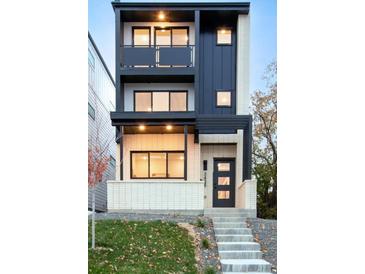 Modern three-story home featuring black metal accents, balconies, and a charming covered front porch at 3435 W 17Th Ave, Denver, CO 80204