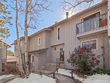 Charming townhome featuring a private balcony, well-maintained landscaping, and a welcoming entrance at 2308 Hearth Dr # 36, Evergreen, CO 80439