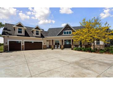 A beautiful home with a well manicured lawn, dormer windows, and a large driveway at 3048 Deer Creek Ranch Loop, Parker, CO 80138
