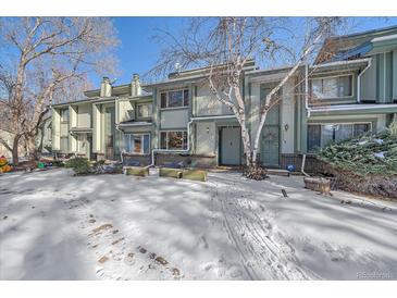 Snow-covered front yard of a charming two-story townhome at 2293 S Oswego Way, Aurora, CO 80014